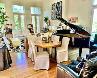 LARGE LIVING AREA WITH MULTIPLE SEATING AREAS, MCGUIRE BY BAKER FURNITURE, GRAND PIANO, SILVER, CHINA, AND UPSCALE DECOR AND RUGS.