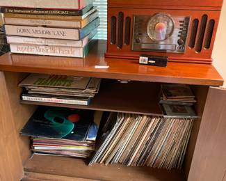 Music box with dozens of albums, harmonica on a beautiful chest.