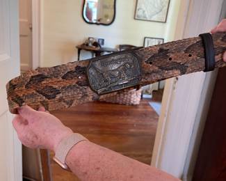 Snakeskin belt with Remington buckle.