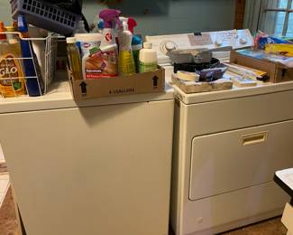 Washer and dryer working with boxes of cleaning supplies