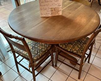 at least 40 years old, solid oak with pedestal and 4 wicker chairs with cushions