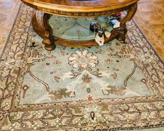 Teal area rug 5 x 7. Large Round coffee table: one of set of 3 tables with carved wood legs and granite top