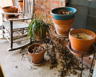 Wood patio rocker. Iron plant stands, pots and planters