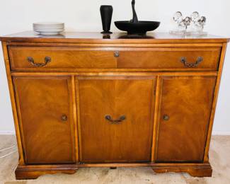 Antique buffet with black porcelain decor and crystal squirl book ends