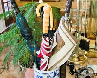 Umbrella stand and umbrellas. Evergreen Tree Live
