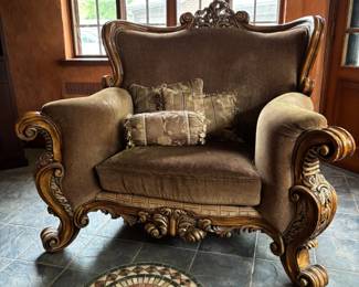 Large Chair
Details: This chair is quite luxurious with its intricate wooden carvings and rich brown upholstery. Very oversized and makes a great statement.
Dimensions: Height (Back) Upholstery Back 46.5”, including wooden crown 53”, Arm Height 32”, Cushion – Width 32” x Depth 27” Overall 53” x 53”
Condition: Gently Used $500