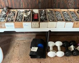 Boxes of hardware, free weights, vintage tennis rackets and tennis totes