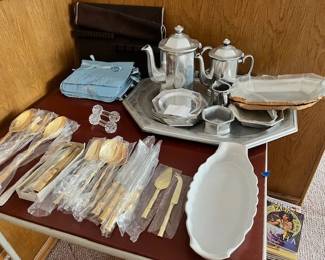 Armetale, gold-plated serving pieces, silverware, and crystal knife rests.
