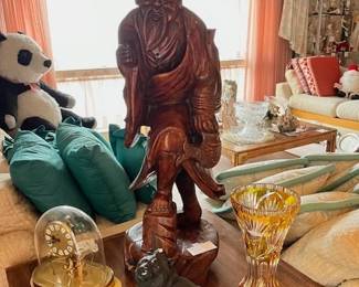 Wood-carved fisherman. Circa 1950. Includes a rod and fish. Crystal amber vase, Vintage stone lion.