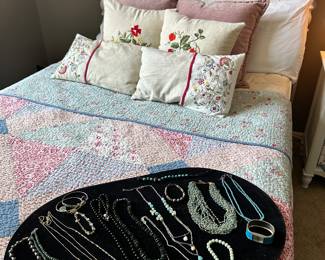 Beautiful Quilt Bedding and Hand Embroidered Throw Pills Shown with Some Lovely Jewlery.
