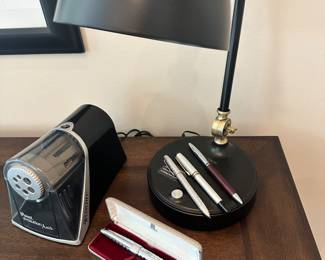  Work Essentials Available Including Cross Pens, iPoint Evolution "Axis" Electric Pencil Sharpener and Great Matte Black OttLite Desk Lamp.