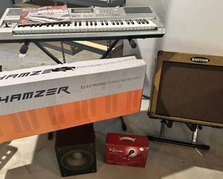 Two Electric Keyboards Available Shown with a Kustom Amp.