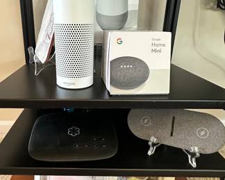 Fabulous Electronics Including a Google Home Mini, Google Home (2018 Model), an Amazon Echo, Ooma Home Tel 2 for Enhanced Wi-Fi Connectivity and a RoHS Wireless Charger.