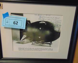 Lot 62 framed photo of Fat Man, second atomic bomb with signature of Lt. Col Olivi, copilot on the mission.