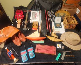 Morse code toy radios, vintage harmonica, toy instruments, new Marlboro belt sack, vintage bike pump, cedar blocks, pool stick, Andrew Wyeth medal lot, vintage paper kites never flown