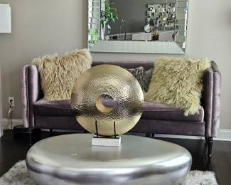 *New contemporary silver river 
  stone coffee table 
*Hammered gold decorative 
   centerpiece 
*Lavender sofa
*Square mirror 
*
