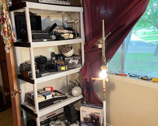 Vintage typewriter, cameras, 8 track tapes, phones, stereos and speakers, lamps clock radios, vintage Rolodex, paper shreader, speakers