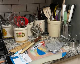 Crocs galore. Utensils. Cutting boards, knives, measuring items.