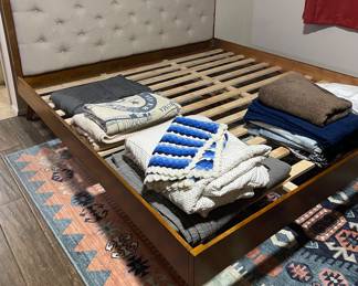 King bedframe, retro styled. Native inspired rug, blankets, etc