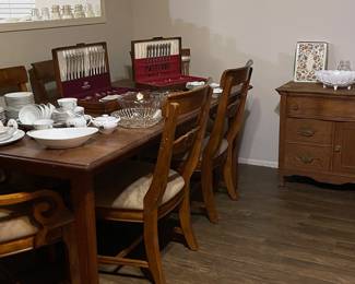 Huge solid, heavy dining table with leaf and 6 chairs. 2 chairs are captains chairs. Seats need recovering. Good strong, sturdy farm table.
