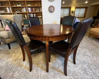Round Dining Table with Four Chairs. Round wooden dining table with a rich finish and four matching black vegan leather upholstered chairs. The set is perfect for cozy dining spaces. Estimated year: 2020. Table is 42” diameter x 30” tall.
Note photos for details and condition. Measurements taken under field conditions are approximate within 1/2". Feel free to reach out with any questions.