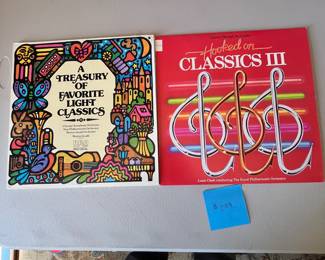 A Treasury of Favorite Light Classics & Hooked on Classics III.
Includes 'A Treasury of Favorite Light Classics' featuring the Chicago Symphony Orchestra, and 'Hooked on Classics III' conducted by Louis Clark, featuring the Royal Philharmonic Orchestra. Both items are vinyl records.
Note photos for details and condition. Measurements taken under field conditions are approximate within 1/2". Feel free to reach out with any questions.
