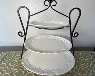 Three-Tiered Serving Stand. Elegant three-tiered serving stand with decorative white ceramic plates featuring a floral design. The stand is made of black metal. Measures 24 inches tall, 20 inches long, and 19 inches deep. Ideal for serving desserts or appetizers. Note repair to top dish of stand.
Note photos for details and condition. Measurements taken under field conditions are approximate within 1/2". Feel free to reach out with any questions.
Items are heavy and we do not assist with loading. Be sure to bring adequate help and a large enough vehicle for large items. If you need assistance, call Denny for an estimate for delivery. (720) 393-0204.