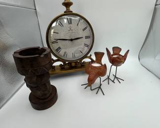 Clock with decorative accessories. This lot includes a beautiful mantel clock, a collectible tiki figure ash tray and two lovely birds. Fun items to round out the decor of a room.
Note photos for details and condition. Measurements taken under field conditions are approximate within 1/2". Feel free to reach out with any questions.