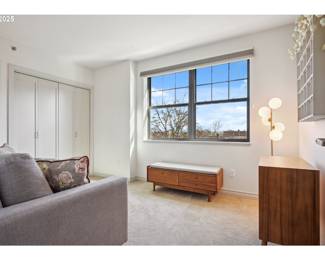 Another shot of side of sofa, midcentury storage bench, side table, floor lamp, wall decor