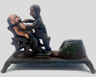 Painted cast iron mechanical bank is a reproduction showing a dentist trying to pull a tooth
