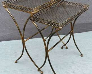 Pair of nesting metal tables with glass tops with graphic text tops