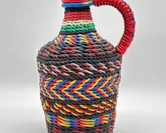 Vintage woven plastic wrapped bottle