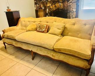 Mid-Century Modern yellow three-seater sofa with button-tufted detailing, dating from the 1950s to 1970s.