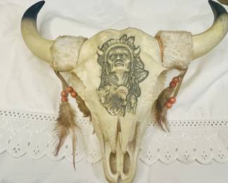 Decorative steer skull with Native American-inspired design.