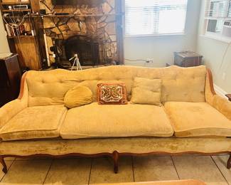 Mid-Century Modern yellow three-seater sofa with button-tufted detailing, dating from the 1950s to 1970s.