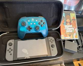 Nintendo Switch with two games and extra controller. Glass protector is cracked, but actual Nintendo screen is perfectly fine.