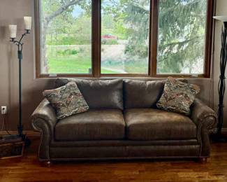 Brown Leather Loveseat with Nailhead Trim Pillows Plus Floor Lamp And Candle Holder