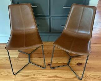 2 West Elm Slope leather chairs.