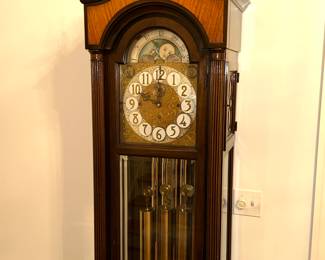 Vintage grandfather clock with moon and sun dial