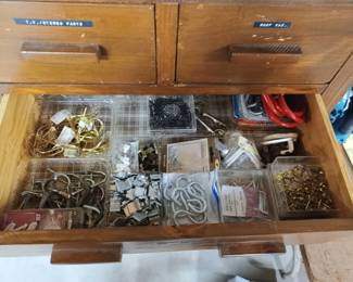 Drawers in wood cabinet are full of supplies of every type