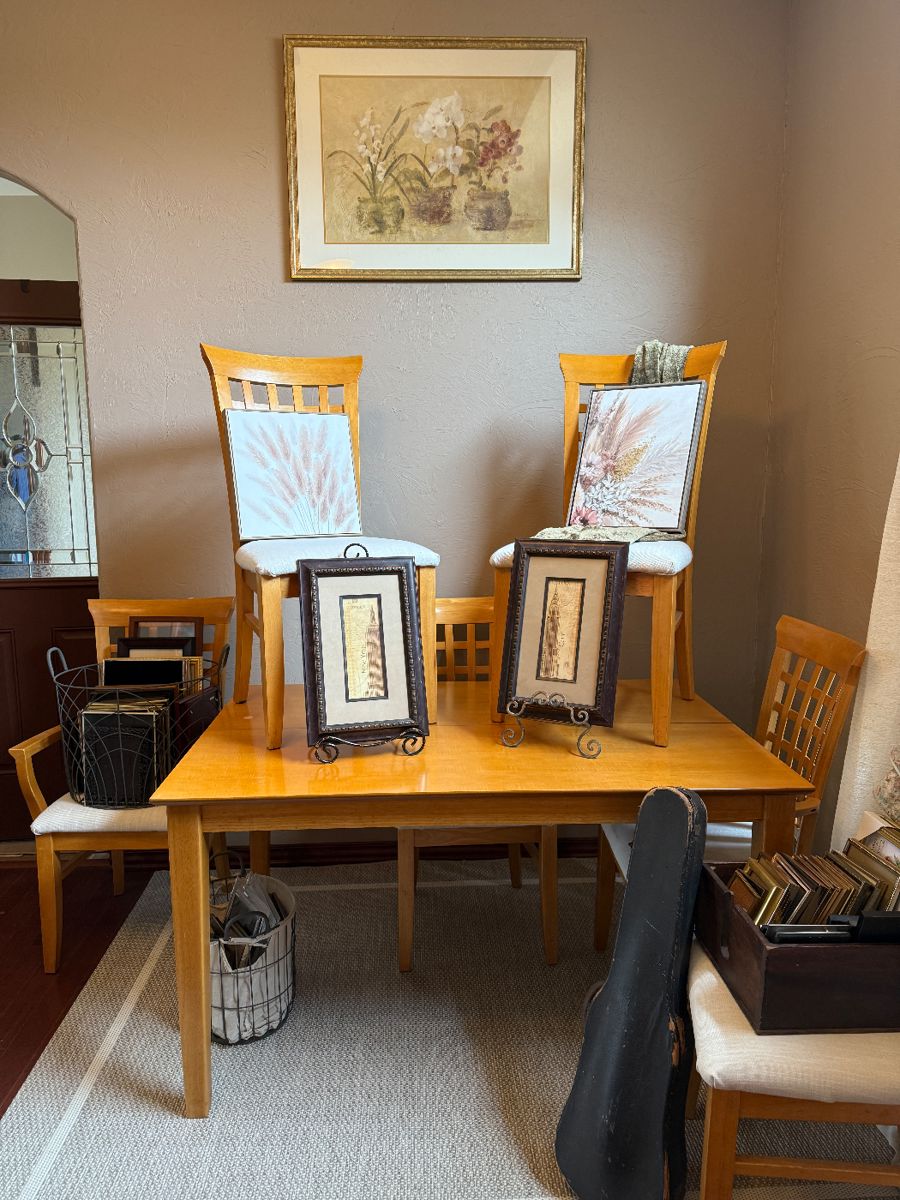 Dining table and six chair chairs. Two chairs are captains chairs.