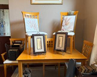 Dining table and six chair chairs. Two chairs are captains chairs.