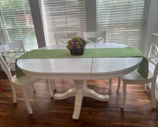Wonderful, white kitchen table and chairs. The leaf is removable.