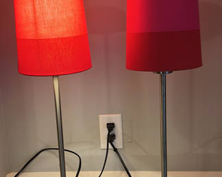 Hot pink and red lampshades on these stick lamps!
