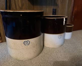 Assorted brown and white crocks in different sizes