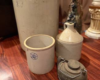 Assorted crocks of various sizes and cast iron