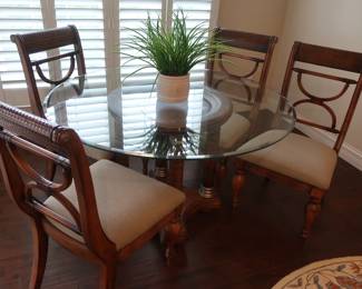 Glass top dinette set with 4 chairs. The table is 50".
