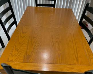 Arhaus kitchen table and chair with a built in leaf