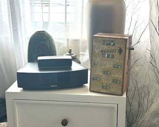 Several table lamps, of various sizes and styles. Small furnishings, such as this set of drawers. Also electonics including a Bose Soundwave CD/Alarm combination, with remote. Soundbar, with remote.