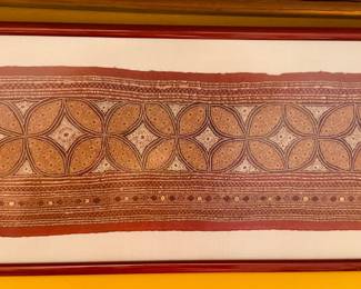 Beautiful framed needlework from Thailand, dated 2009. Red metal frame is approximately 21.5" x 10"